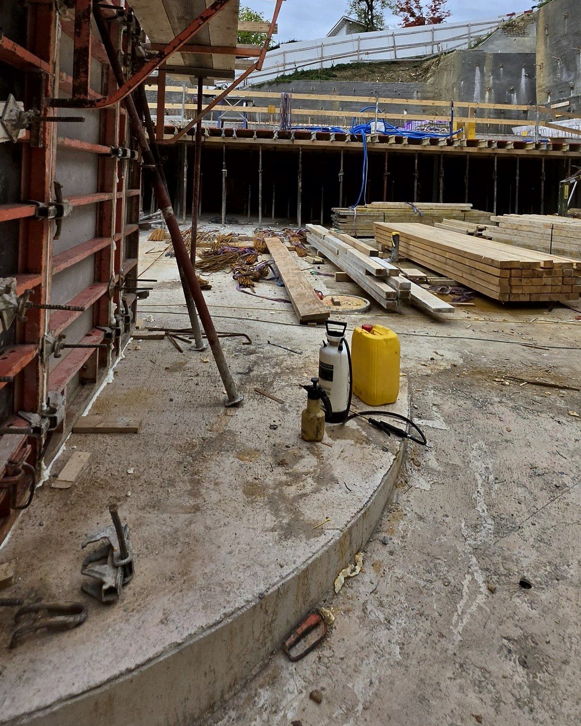 Curved wall formwork with walkway, slab formwork on props behind