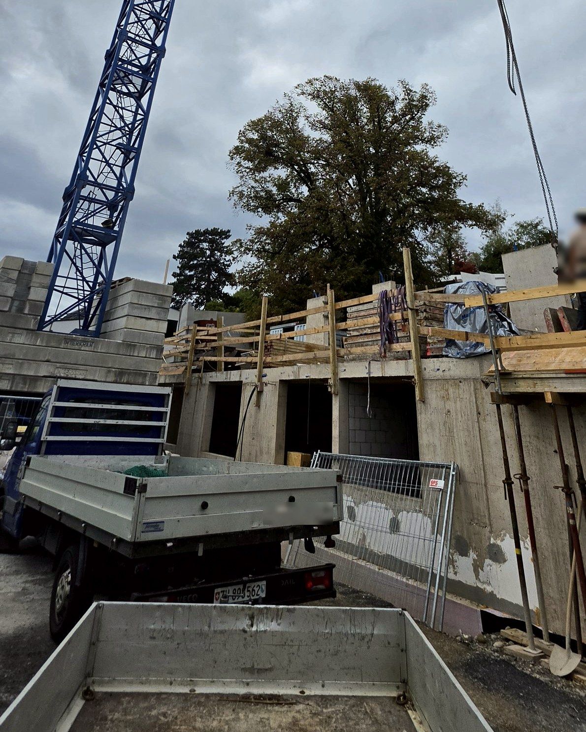 Tower crane above the shell, van in front, number plate made unrecognisable