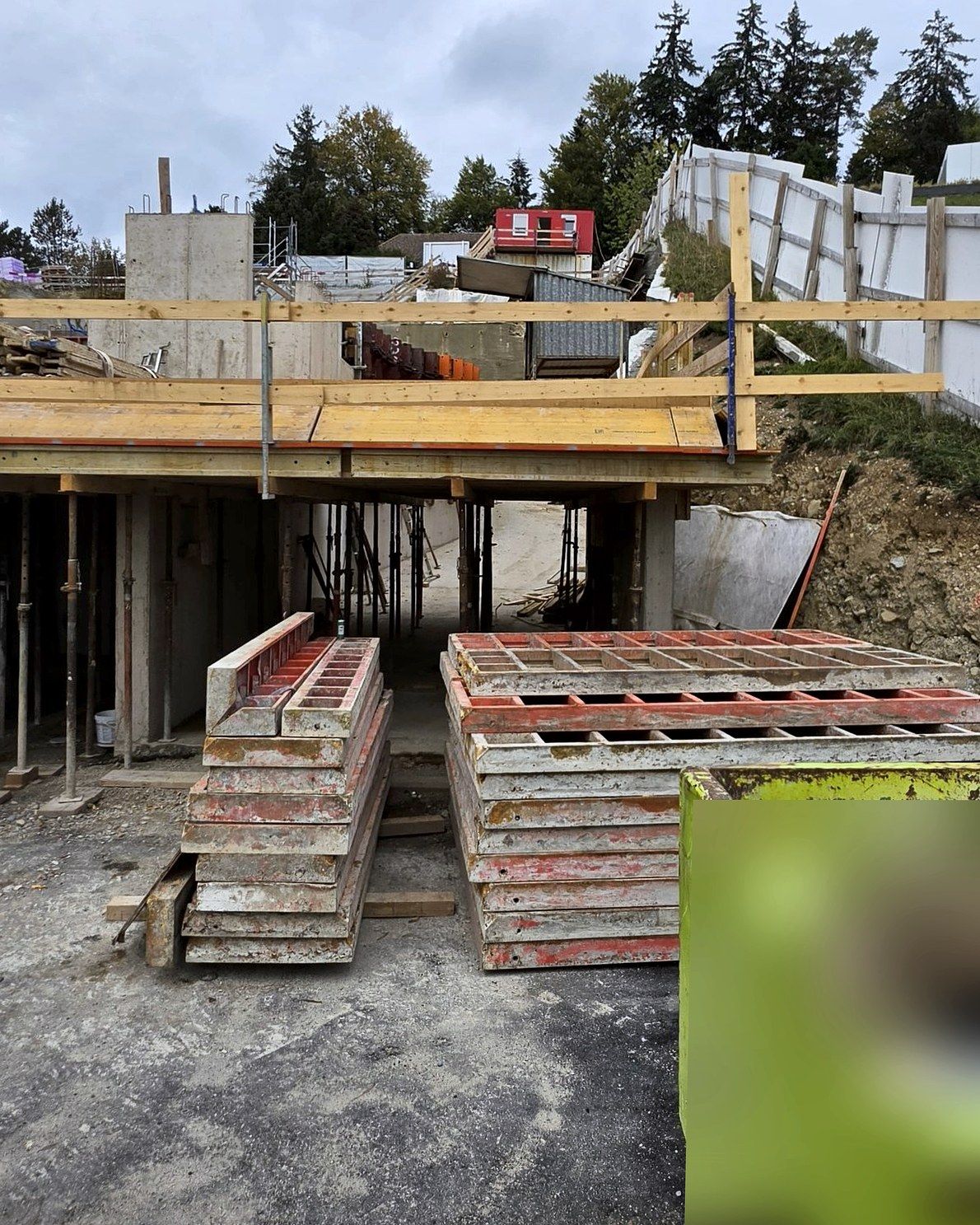 Slab formwork over the entrance, stacked formwork panels, container made unrecognisable